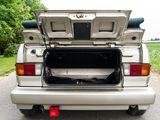 a silver car with its trunk open on the road