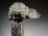 an image of a sculpture of a head on a marble block