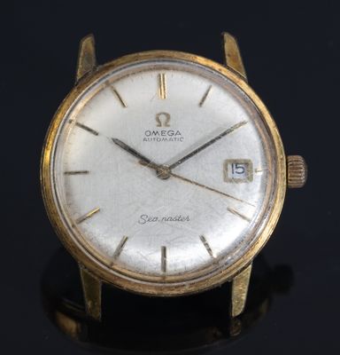 an image of a close up of a gold watch on a black surface