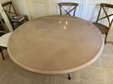 a round table with chairs around it in a room