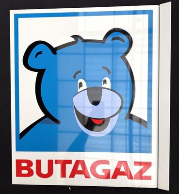 a poster of a blue bear with a big smile on it