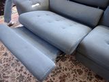 a blue couch with a recliner on it in a living room