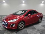 a red car is parked in a room with a checkered floor