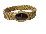 an image of a gold bracelet with a black stone in the center