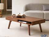 a coffee table with a drawer on it in a living room