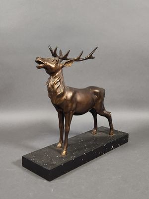 bronze sculpture of a stag on a marble base