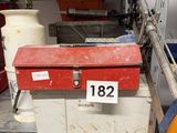 a red tool box sitting on top of a metal shelf