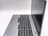 a silver laptop computer sitting on top of a white table
