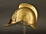 an antique helmet on a stand with a black background