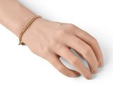 gold plated bracelet with a star charm on a mannequin hand