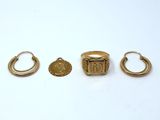 three gold rings and a ring with a coin on it
