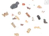 a lot of small toys that are on a white surface