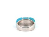 a close up of a ring with a turquoise stone in it