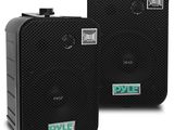 two black speakers sitting side by side on a white surface