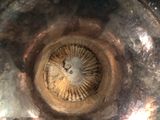a close up of a metal bowl with a metal lid