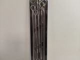 a close up of a package of metal scissors on a white surface