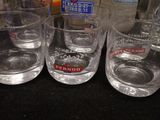 several glasses of water are lined up on a counter