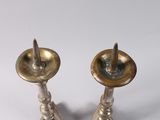 pair of antique brass candlesticks on a white background