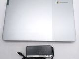 a laptop and a charger sitting on a table