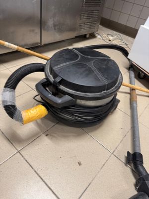 a vacuum that is sitting on the floor in the kitchen
