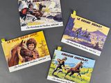 four postcards of western movie posters are displayed on a table