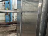 an image of a stainless steel refrigerator inside of a building