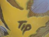 a yellow vase with a blue and yellow design on it