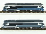 two different views of a blue and white train on the tracks