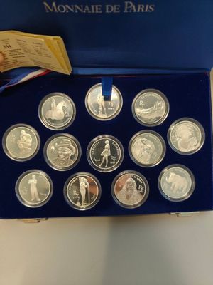 an image of a blue box containing a collection of silver coins