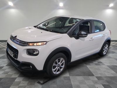 the white citrole is parked on a checkered tile floor