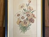 an old picture of a bunch of flowers on a wooden table