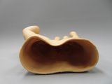 a sculpture of a person laying down on a pillow