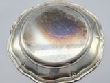 a silver plate with a silver lid on a table