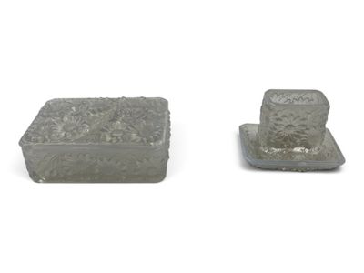 two pieces of glass sitting next to each other on a white surface