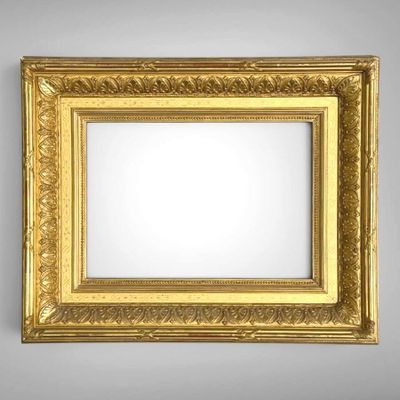an old gold frame with a decorative pattern on a gray background