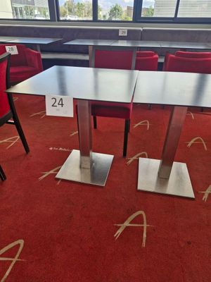 a table and chairs in a room with a red carpet