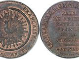 a close up of a coin on a white surface