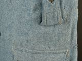 a close up of a blue coat with buttons on it