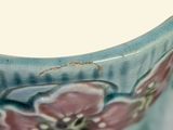 a close up view of a vase with a flower on it