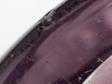 a close up of a purple object on a white surface