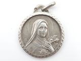 a close up of a silver medal on a white surface