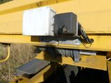 a close up of a yellow truck with a box on it