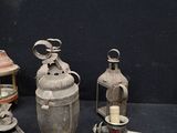 many different types of antique lanterns on a table
