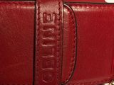 a red purse with a gold chain around it