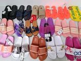 many pairs of slippers that are lined up on a table
