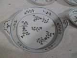 a white table topped with blue and white plates and bowls