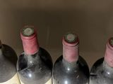 several bottles of wine are lined up in a row on a table
