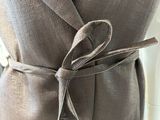 a close up of a dress with a tie around the waist