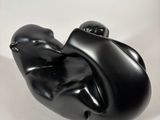 black sculpture of a hand holding a black object on a white surface