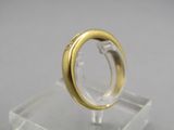 a gold ring sitting on top of a clear stand